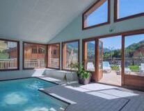 a room with a pool in front of a window
